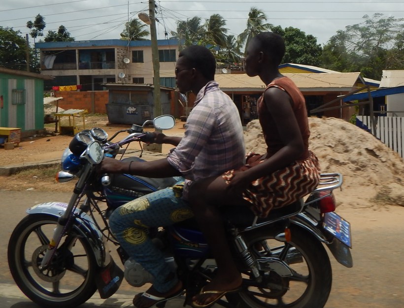 Man and woman riding the moto near the Volta Region.